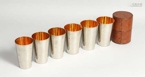 SIX GRADUATED DRINKING BEAKERS in a leather case.