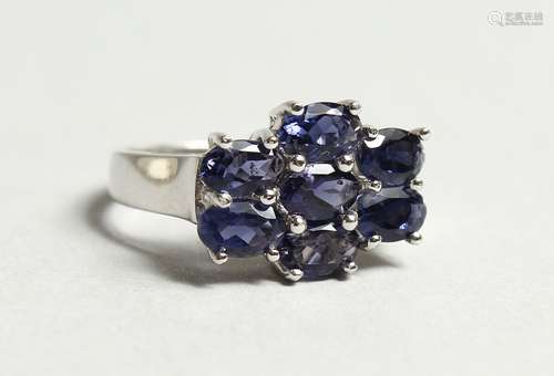 A SILVER AND SEVEN STONE SAPPHIRE RING