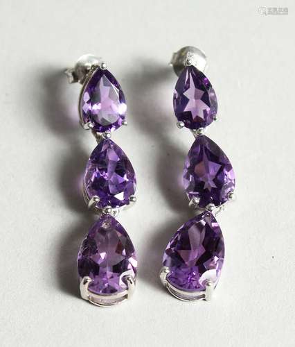 A PAIR OF SILVER THREE TIER AMETHYST DROP EAR RINGS