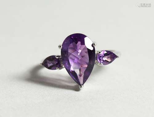 A SILVER THREE STONE AMETHYST RING