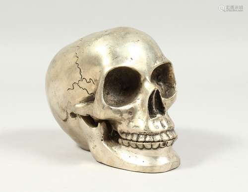 A SILVER PLATED BRONZE SKULL 5ins high