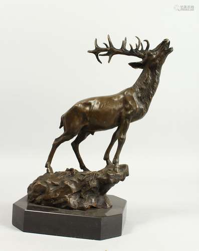 A CAST BRONZE MODEL OF A STAG ON A ROCKY OUTCROP, mounted on...