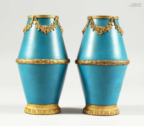 A SMALL PAIR OF SEVRES BLUE GROUND VASES with gilt garlands ...
