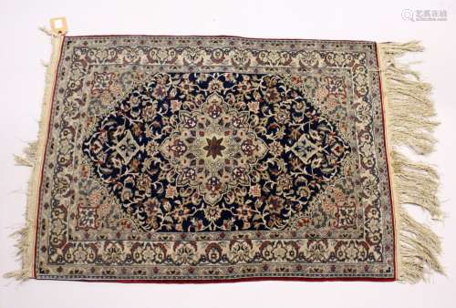 A GOOD, SMALL PERSIAN RUG, dark blue ground with stylised de...