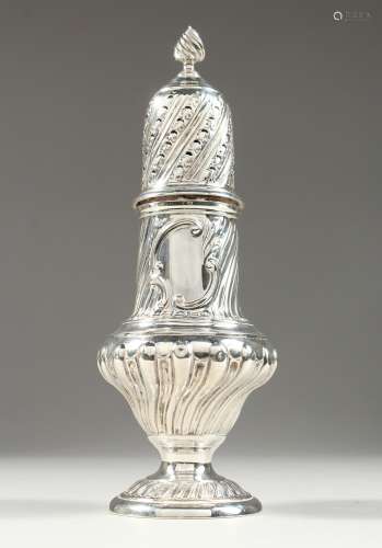 A VICTORIAN SUGAR SIFTER with repousse decoration. 9ins high...
