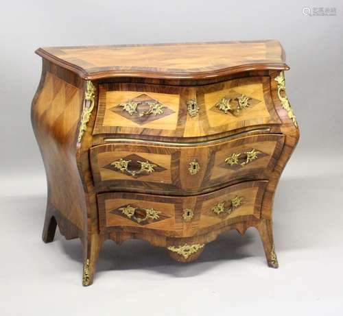 A GOOD SERPENTINE FRONTED BOMBE COMMODE, with cross banded t...