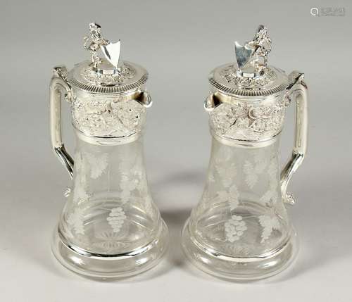 A GOOD PAIR OF ETCHED GLASS CLARET JUGS with plated mounts