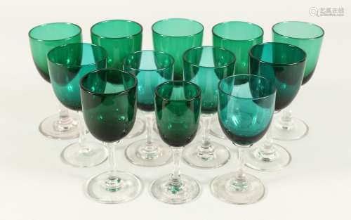 TWELVE MIXED VICTORIAN GREEN TINTED WINE GLASSES.