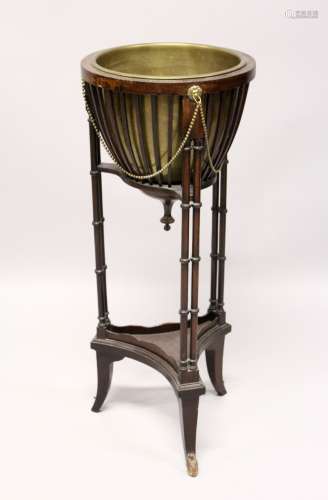 A MAHOGANY JARDINIERE with brass bowl and double column supp...