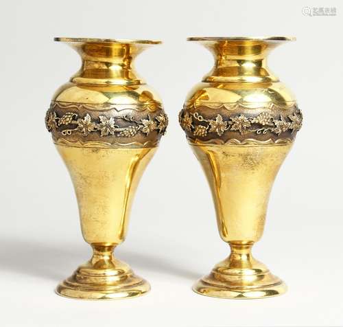 A GOOD PAIR OF SILVER GILT VASES, cast with a band of fruiti...