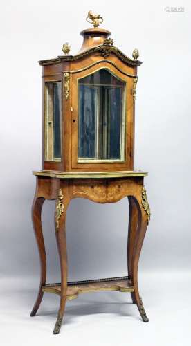 A GOOD LOUIS XVI STYLE SERPENTINE FRONTED STANDING DISPLAY C...