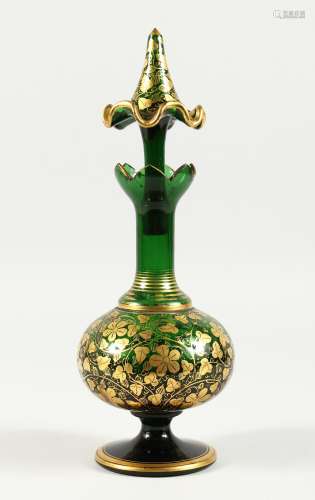 A BOHEMIAN GREEN AND GILT DECANTER AND STOPPER 10.5 ins high...