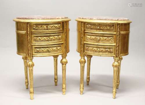A PAIR OF FRENCH STYLE GILT WOOD OVAL THREE DRAWER BEDSIDE C...