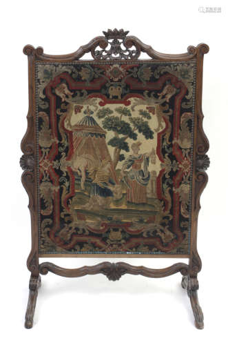 A 19th century French oak and petit point fire screen