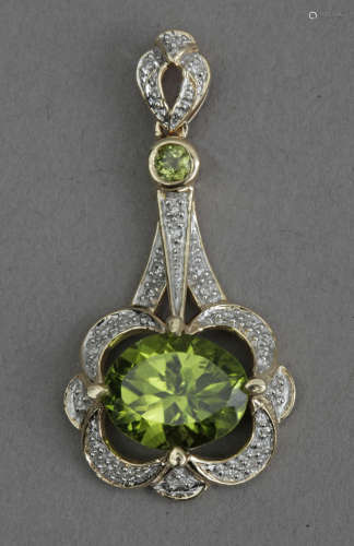 A diamond and diopside pendant in an 18k. yellow gold settin...