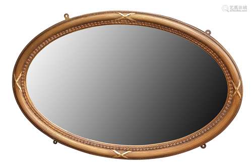 A NEO-CLASSICAL STYLE OVAL GILT FRAMED MIRROR