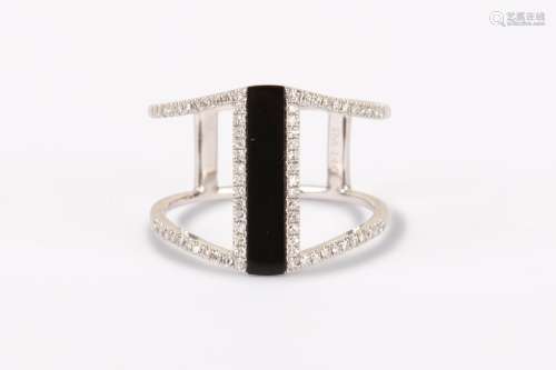 AN ONYX AND DIAMOND DRESS RING