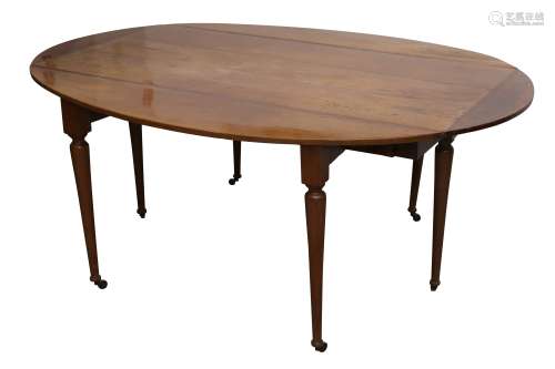 A CONTINENTAL FRUITWOOD DROP LEAF DINING TABLE