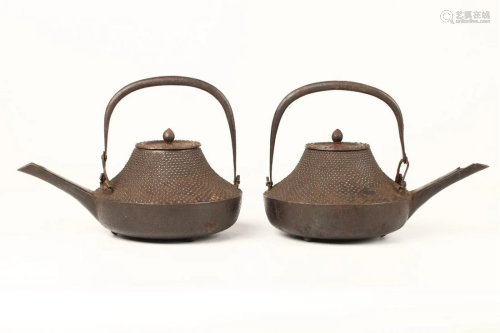 A PAIR OF JAPANESE IRON POTS