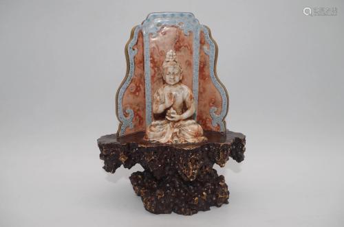 A SITTING BUDDA MADE OF PORCELAIN