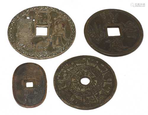 A collection of four Chinese metal coins,