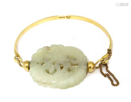 A Chinese jade and gold bangle,