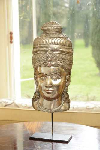 A white metal relief mask,