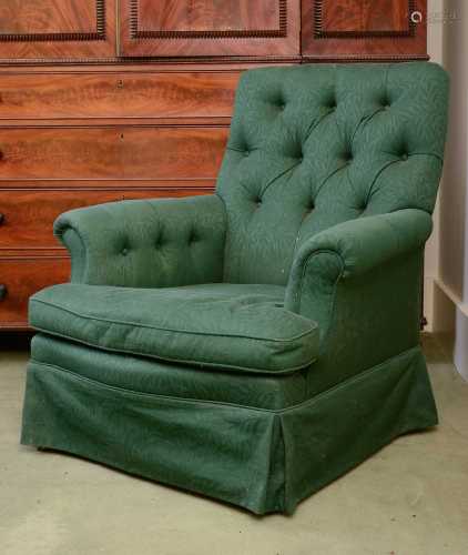 A green button upholstered armchair,