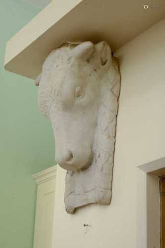 A pair of carved marble bucrane corbels,