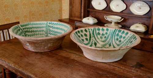 A pair of very large partially-glazed earthenware bowls,