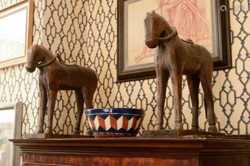 A pair of carved wooden horses,