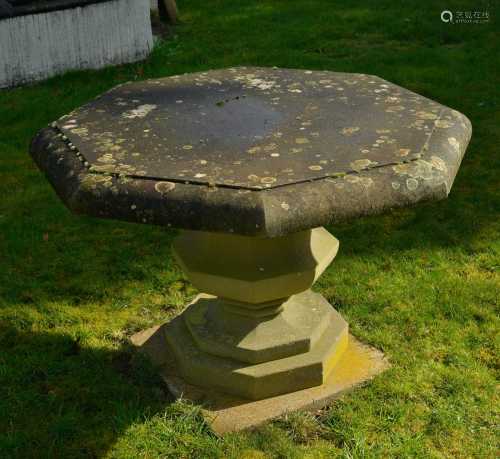 An octagonal reconstituted stone garden table,