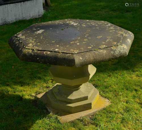 An octagonal reconstituted stone garden table,