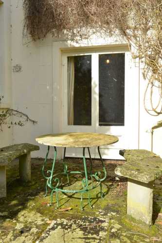 A marble-topped wrought iron garden table,