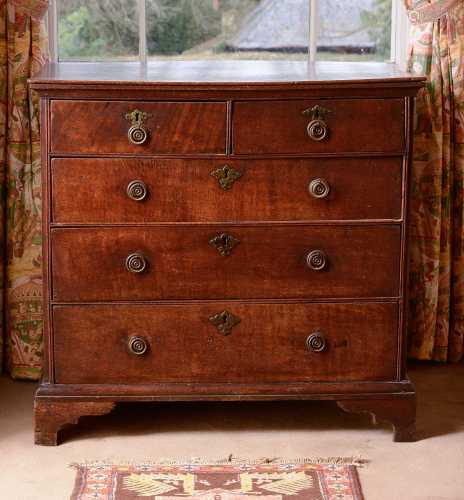An oak chest of two short over three long drawers,