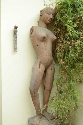 A near pair of life-sized carved wooden standing female figu...