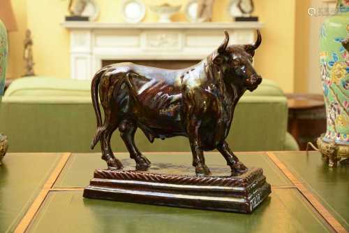 A large brown-glazed pottery model of a bull,