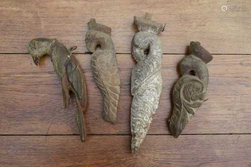 Four carved wooden figures of birds,