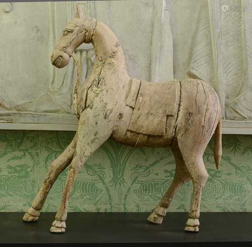 A carved wooden figure of a horse,