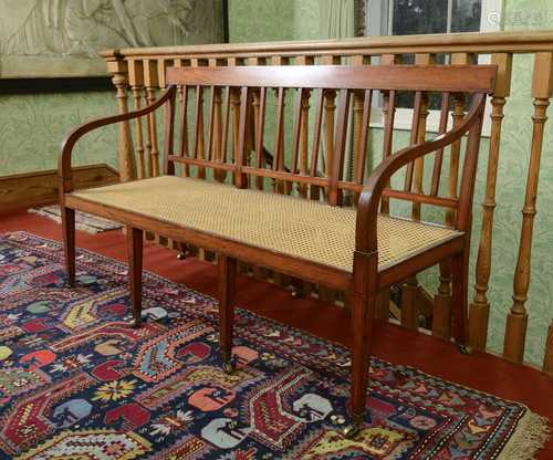 A Regency-style satinwood settee,