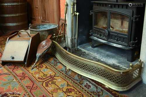 A serpentine brass fireguard,