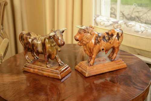 A pair of treacle-glazed pottery bulls,