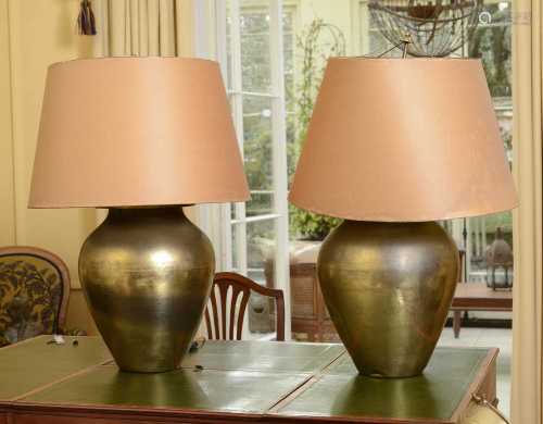 A pair of large hammered brass table lamps,