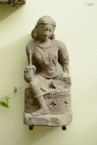 A carved sandstone figure of a dancer,