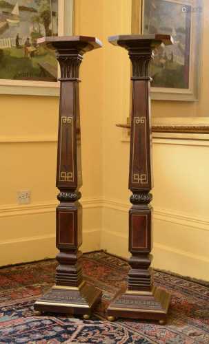 A pair of mahogany torchères in the manner of George Bullock...