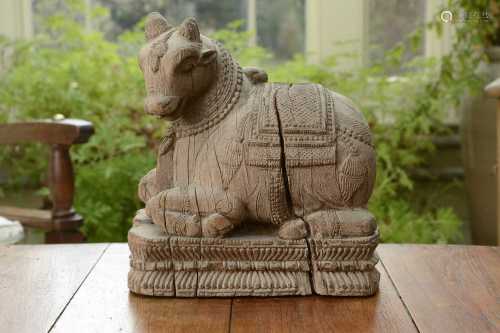 A carved teak figure of the Nandi Bull,