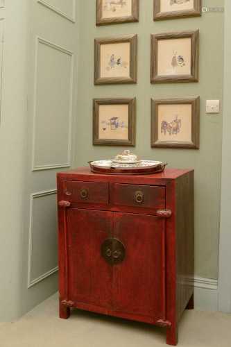 A Chinese red-lacquered low cupboard,