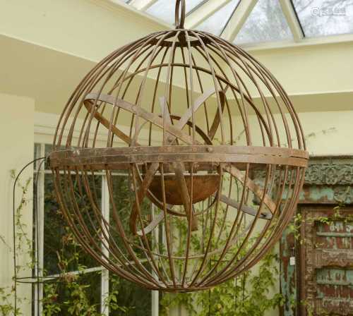A large wrought iron gimballed light fitting,