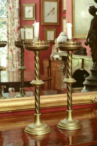 A pair of ecclesiastical brass candlesticks,