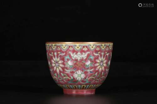 A CARMINE GROUND INTERLOCKING LOTUS BAT PATTERN CUP